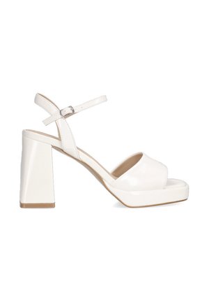 Sandalias de tacón alto de charol blanco con plataforma, punta abierta y tira al tobillo. Presenta un elegante tacón cuadrado y una textura suave.