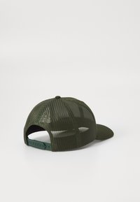 Green mesh cap with a curved visor, adjustable snapback closure, and tonal stitching. Features a solid back and ventilation panels.