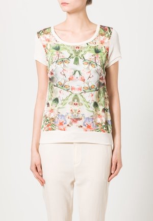 T-shirt graphique floral à manches courtes, fond crème et impression botanique vibrante. Tissu doux avec une coupe décontractée.