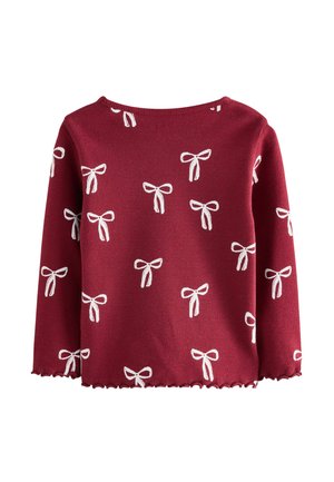 Punainen neulepaita, jossa on valkoisia nauhamalleja, pyöreä pääntie, pitkät hihat ja aaltoileva helma. Pehmeä rakenne, jossa on ribbikudos.