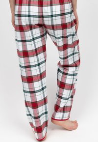 Pantaloni del pigiama a quadri rossi e bianchi con dettagli verdi, in cotone, vestibilità comoda, vita elasticizzata e dettagli a costine sui polsini.