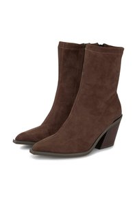 Botines de ante marrón con punta afilada y tacón de cuña texturizado. Cuentan con una cremallera lateral para facilitar el uso. Superficie lisa y suave.