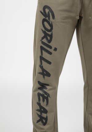 Olijfgroene sweatpants met een relaxte pasvorm, voorzien van een grote zwarte grafische 'GORILLA WEAR' die langs het linkerkuit is gedrukt. Gemaakt van zachte stof.