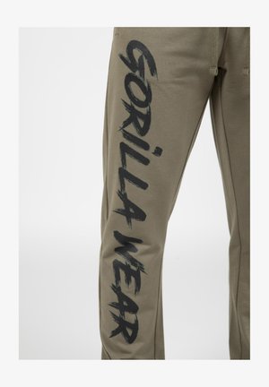 Olijfgroene sweatpants met een relaxte pasvorm, voorzien van een grote zwarte grafische 'GORILLA WEAR' die langs het linkerkuit is gedrukt. Gemaakt van zachte stof.
