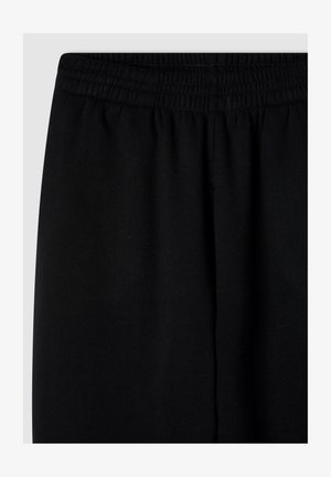 Pantaloni da jogging neri con vita elasticizzata, texture del tessuto morbida e un design semplice a gamba dritta senza ulteriori motivi o accenti.