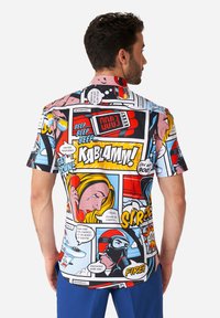 Short-sleeve button-up shirt featuring a colorful comic-style print with various illustrations and text, predominantly in shades of red, blue, and yellow.