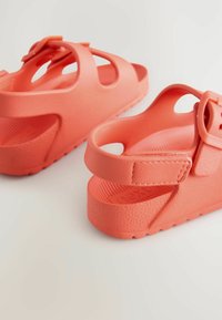 Korallrosa sandaler i texturerad gummi, med öppen tådesign, kraftig sula och justerbara remmar med spänne.