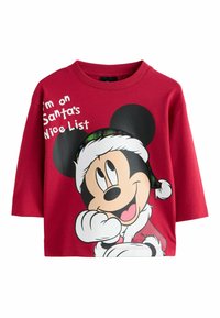 Červená bavlnená mikina s okrúhlym výstrihom. Na prednej strane sa nachádza potlač Mickey Mouse v santa čiapke a text "Som na Santa zozname tých, ktorí boli hodní."