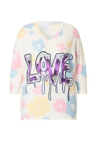 Bluzka z dekoltem w serek, oversize w kremowym kolorze z pastelowym wzorem kwiatów. Posiada wyraźny fioletowy napis "LOVE" z kroplami na końcach. Wykonana z mieszanki bawełny.