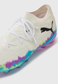 White knitted soccer cleat, features a multicolored gradient pattern in blue, purple, and green at the base, with black Puma logo and white laces.