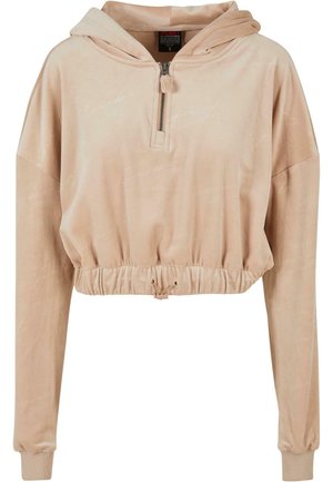 Kuttet, beige hettegenser laget av mykt stoff, med glidelås foran, elastisk midje og lange ermer med ribbestrikkede mansjetter.