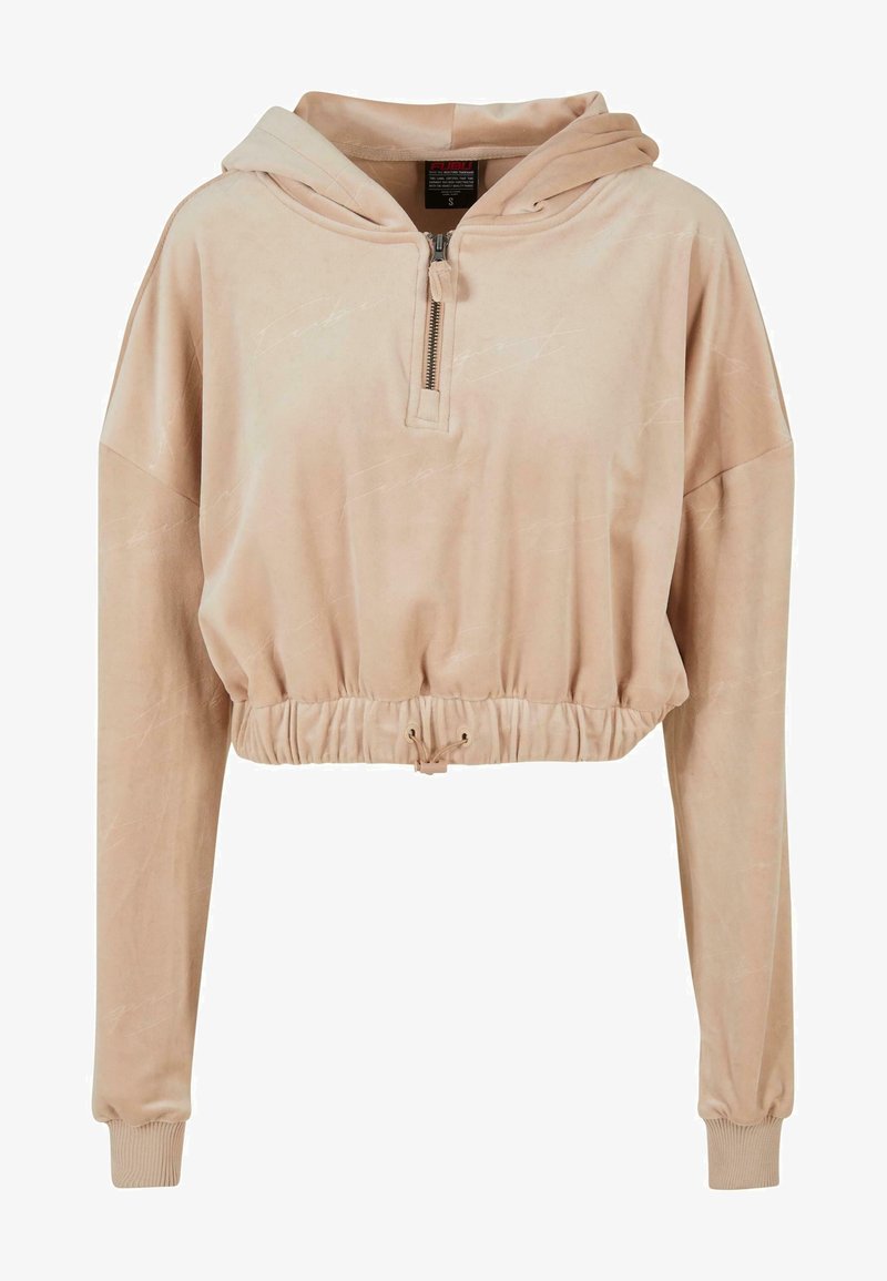 Lyhyt beige huppari, joka on valmistettu pehmeästä kankaasta, ja siinä on puolivetoketjullinen etuosa, joustava vyötärö sekä pitkät hihat ribbineuloksilla.