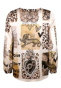 Long-sleeve top featuring a mix of animal prints and graphics, including tigers, hearts, and floral designs in beige and brown tones.