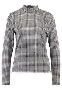 Långärmad polotröja i ett svart och vitt hundtandsmönster, med en figurnära design och ett texturerat, stickat tyg.