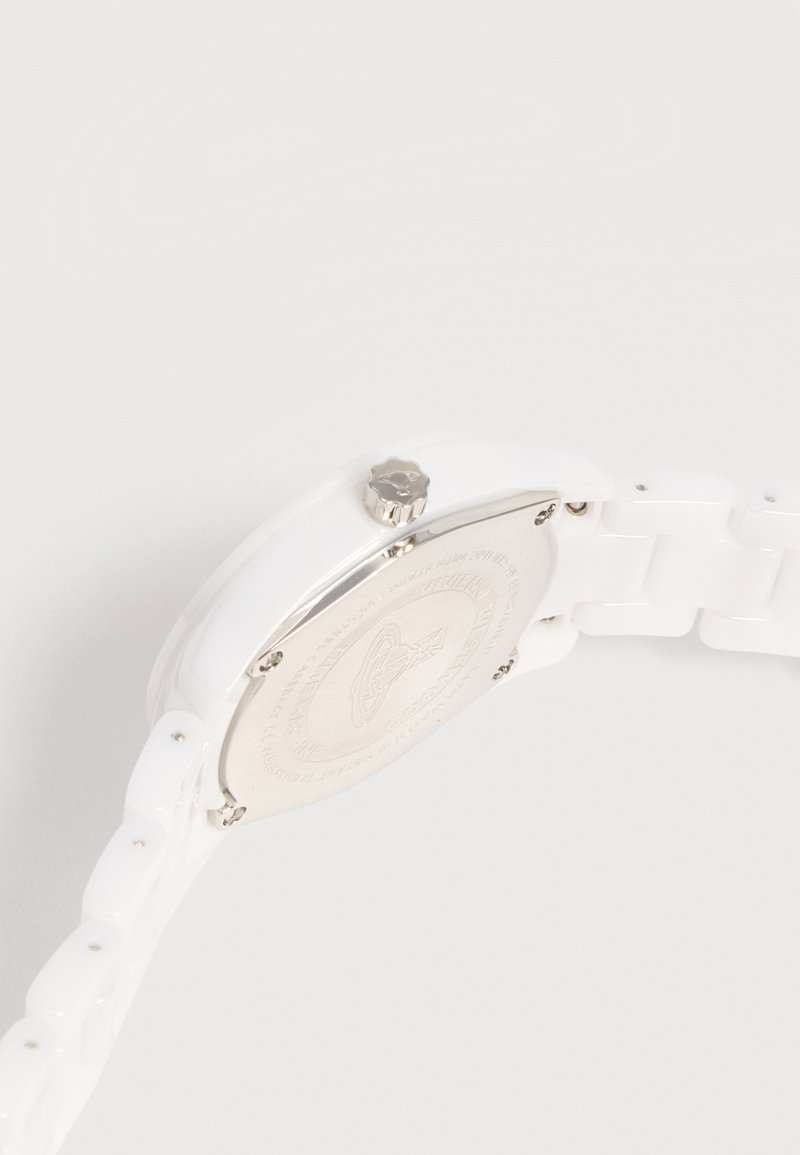 White wristwatch with a silver backplate and crown, featuring a linked strap and engraved logo on the back.