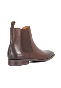 Brown leather Chelsea boot with elastic side panels, smooth texture, and a low stacked heel. Features a pull tab for easy wear.
