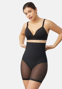 Pantalones cortos moldeadores de cintura alta en negro, con una tela suave, paneles transparentes en los muslos y tirantes ajustables. Diseñados para una silueta ajustada.