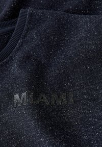 Marineblå genser med teksturert finish, med ordet "MIAMI" i svart tekst på fronten, ribbet halslinning og subtil glans.