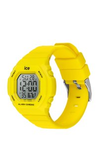 Orologio digitale giallo con cinturino in plastica, presenta un quadrante quadrato, display LCD che mostra ora e data, e pulsanti funzione sul lato.