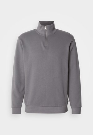 Sweatshirt gris à col zippé avec manches longues. Fabriqué en tissu doux, il présente une fermeture éclair de quart de longueur ainsi que des poignets et un ourlet côtelés.