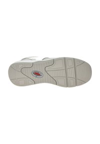 White athletic shoe sole featuring textured rubber with a tread pattern, a circular logo in red and gray, and a slightly curved shape.