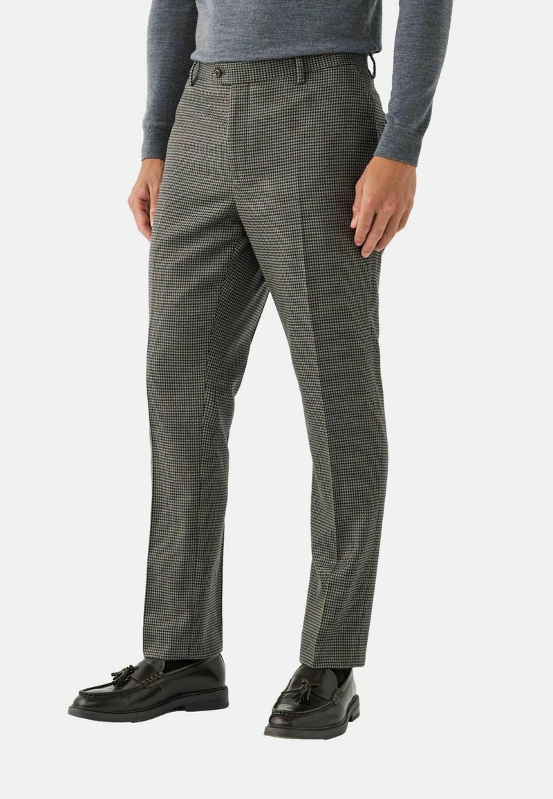 Checked trousers in gray and black fabric, tailored fit with a smooth texture. Paired with black leather loafers.