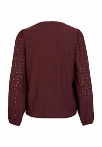 Bourgognebluse med tekstureret, mønstret stof, lange puffede ærmer og rund halsudskæring, designet med en afslappet pasform.