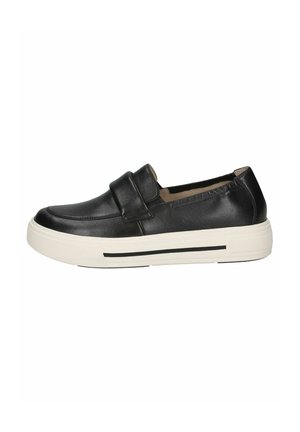 Black leather slip-on shoes with a flat white sole, featuring a wide strap across the midsection and a smooth surface texture.