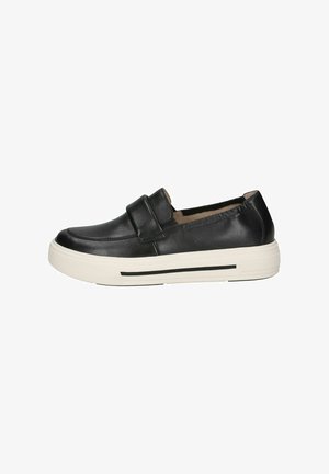 Black leather slip-on shoes with a flat white sole, featuring a wide strap across the midsection and a smooth surface texture.