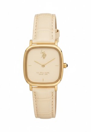 Montre-bracelet carrée dorée avec bracelet en cuir beige, cadran minimaliste, et logo ainsi que texte U.S. Polo Assn. sur le cadran.