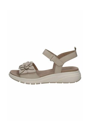 Sandale beige avec application florale, bride de cheville ajustable, semelle intérieure rembourrée et semelle texturée pour l'adhérence. Design élégant et contemporain.