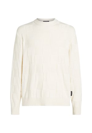 Pull en tricot crème avec un motif carré texturé, col rond et poignets côtelés. Étiquette sur le côté.