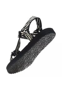 Sandale à semelle noire avec des brides en tissu réglables à rayures zèbre et une semelle texturée, vue en contre-plongée.