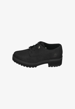 Black suede lace-up shoes with a rounded toe, textured upper, and rugged rubber sole featuring low-profile tread pattern.