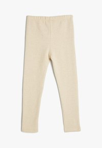 Leggings beige con un patrón de espiga, fabricados en tejido suave y elástico. Cuentan con una cintura elástica y piernas ajustadas.