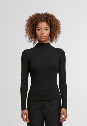 Schwarzes langärmliges Oberteil mit Mock-Neck aus weichem Material, figurbetontem Design, glatter Textur und minimalen Nähten auf einem hellen Hintergrund.