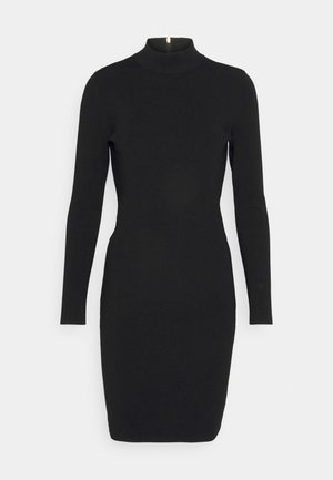 Robe noire à manches longues avec col montant et coupe ajustée. Présente un léger brillant, une fermeture éclair dans le dos et une texture en tricot lisse.