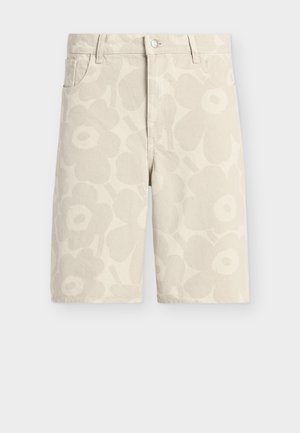Short beige mi-longue avec un motif floral subtil, poches avant, passants de ceinture et fermeture par bouton.