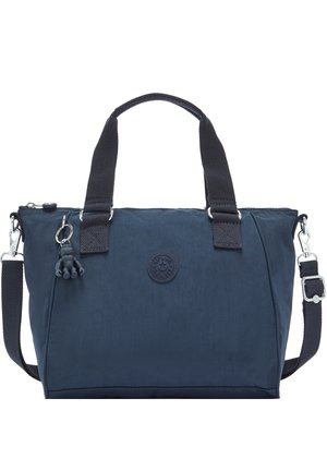 Marineblauwe tote bag met twee zwarte handvatten, afneembare schouderriem en een klein apensleutelhanger bevestigd vlak bij de rits.