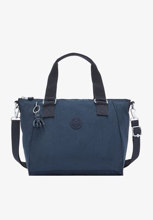 Marineblauwe tote bag met twee zwarte handvatten, afneembare schouderriem en een klein apensleutelhanger bevestigd vlak bij de rits.