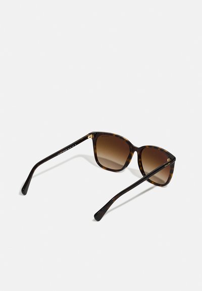 Tortoiseshell sunglasses with gradient brown lenses, featuring a rounded frame, slim arms, and gold accents on the hinges.