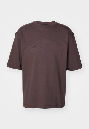 Dark brown cotton t-shirt featuring a crew neckline and short sleeves. Embossed "DSQUARED2 ICON" logo across the front. Loose fit.