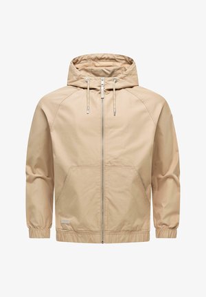 Beige windbreaker met capuchon, voorzien van een rits aan de voorkant, trekkoord aan de capuchon, elastische manchetten en twee steekzakken aan de voorkant.