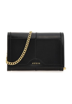 Black Guess clutch purse with gold chain strap and gold logo, featuring stitched panel design.