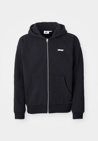 Black zip-up hoodie made of cotton blend fabric. Features a front pocket, ribbed cuffs, and a small white "obey" logo on the chest.