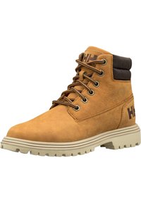 Tan leather hiking boot with a padded brown collar, metal eyelets, and a thick rubber sole featuring deep traction grooves. Logo on the side.