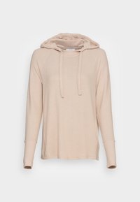Ljust beige hoodie med ett mjukt, texturerat tyg. Har en dragsko i huooden, raglanärmar och sidofickor för ökad komfort.