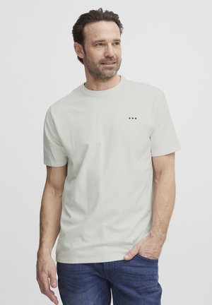 Light gray short-sleeve t-shirt with a round neckline and small tri-color embroidered logo on the chest, made from smooth cotton fabric.