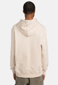 Light beige hoodie with a soft texture, featuring a large adjustable hood, ribbed cuffs, and hem, and a relaxed fit.