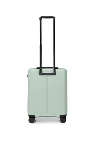 Mint green hard-shell suitcase with vertical ribbed texture, retractable black handle, and four black wheels for mobility.